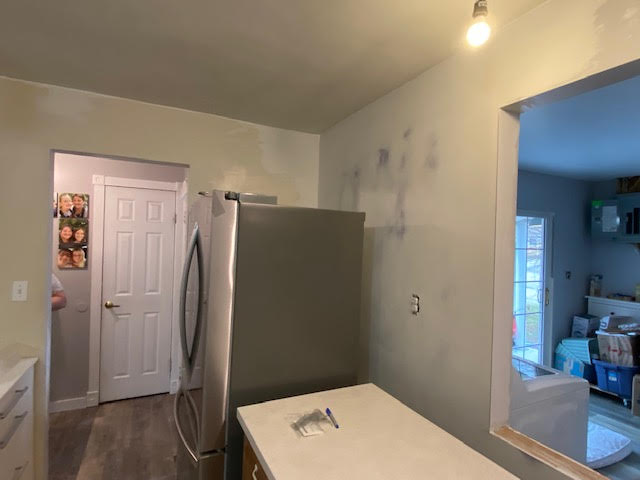 Kitchen wall repairs with new drywall finish